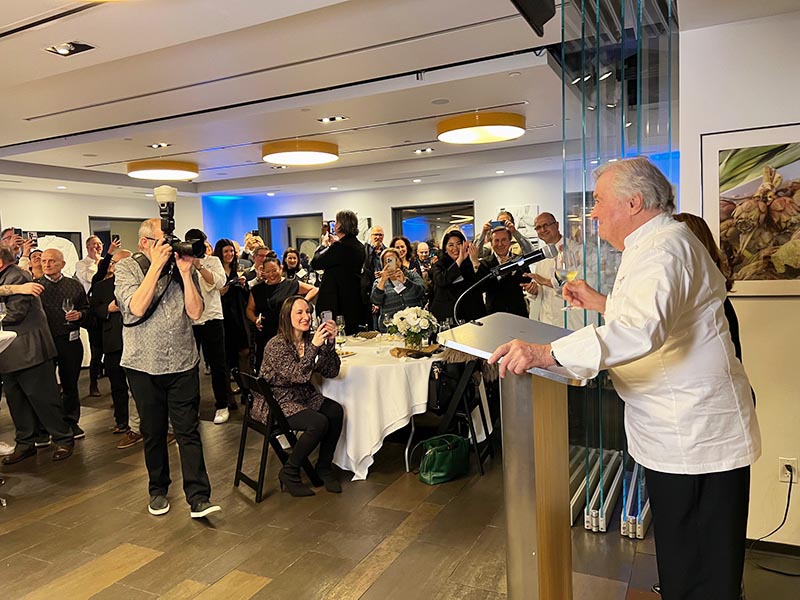 Jacques Pépin giving a speech at the Institute of Culinary Education.