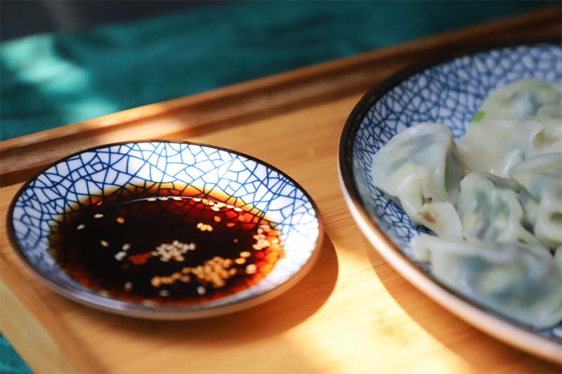 Soy sauce with dumplings for dipping.