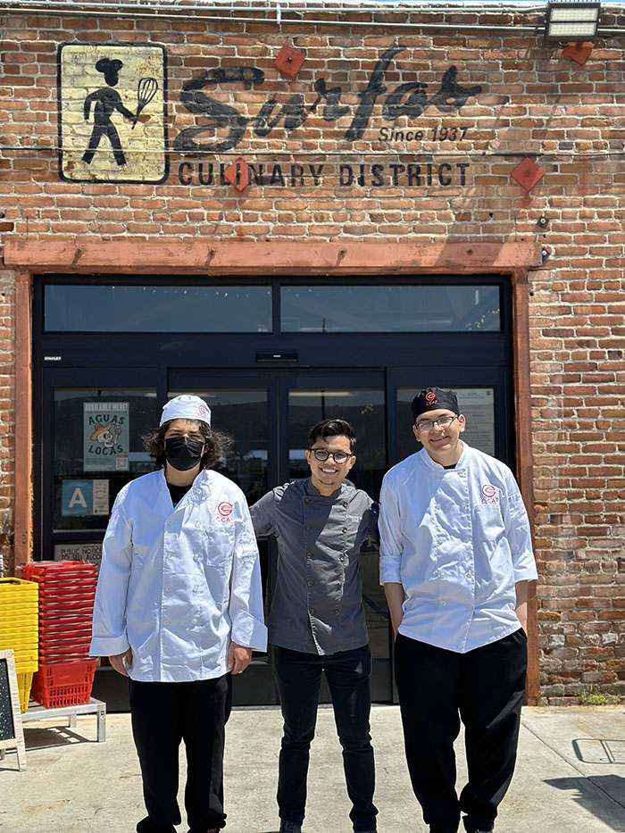 Emerson Majano and two chefs in front of Surfas in Los Angeles.
