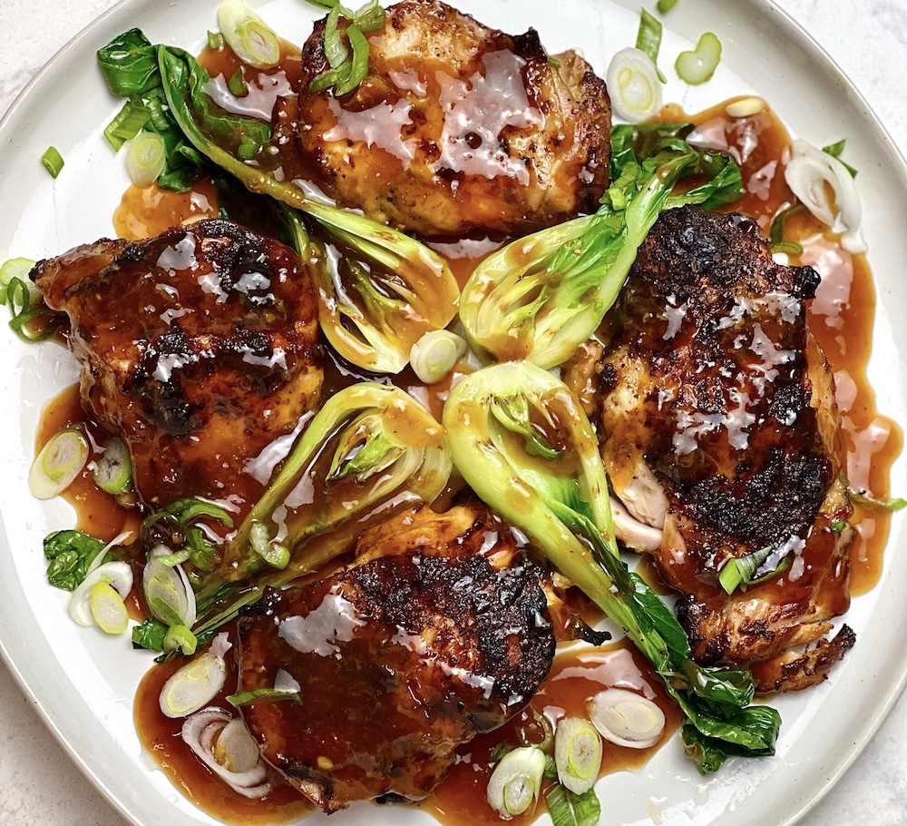 A plated chicken and bok choy dish made by an online culinary school student