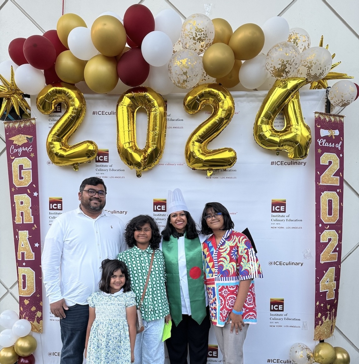 ICE online culinary school graduate Zakia "Trisha" Answary smiles with her family at commencement