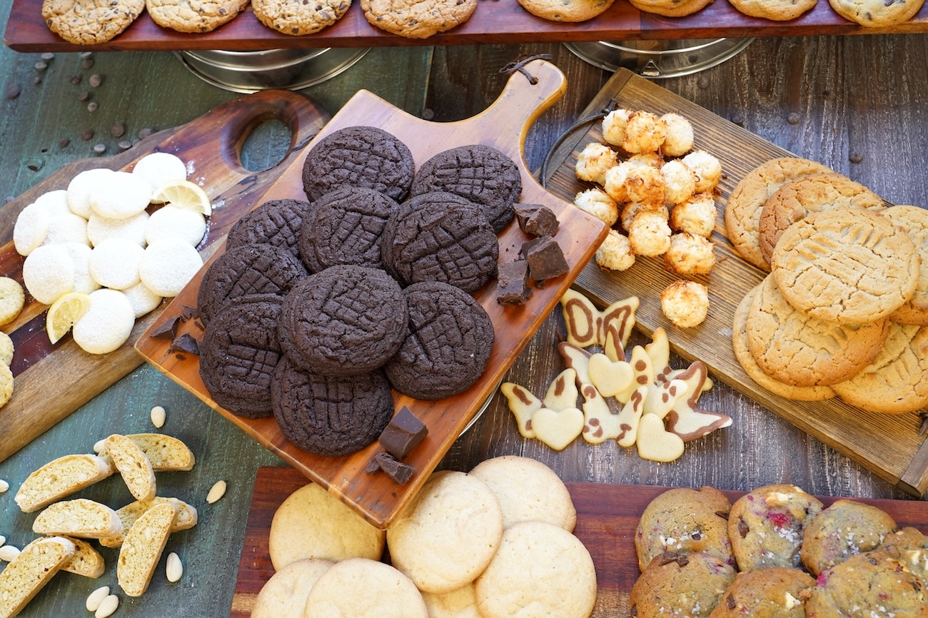 A spread of many different types of cookies sits on a table