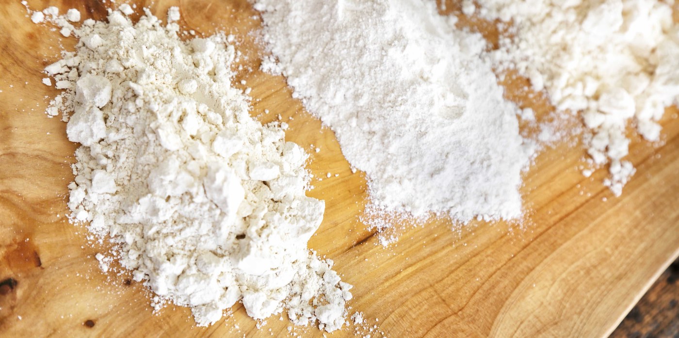 White flours laid out in columns on a wooden board