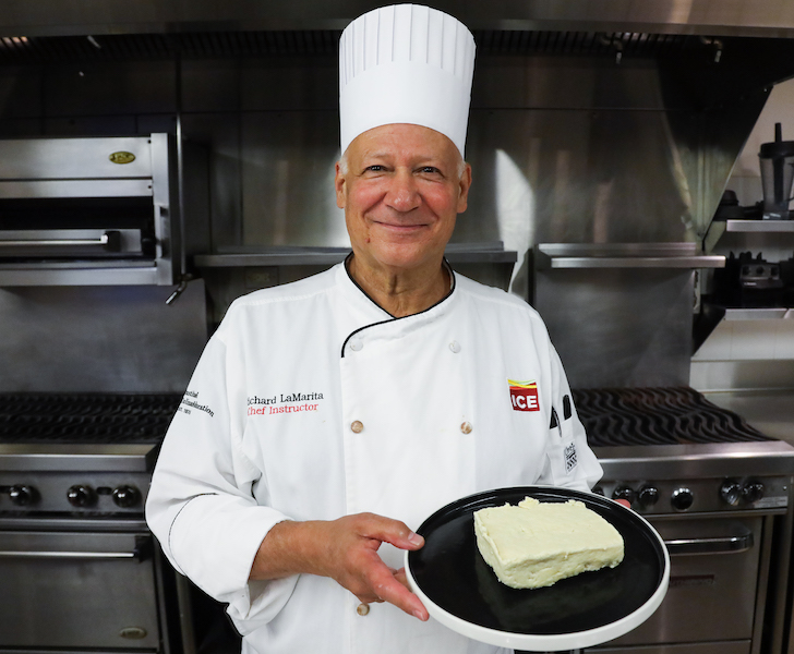 Chef Rich holding a plate with a tofu block