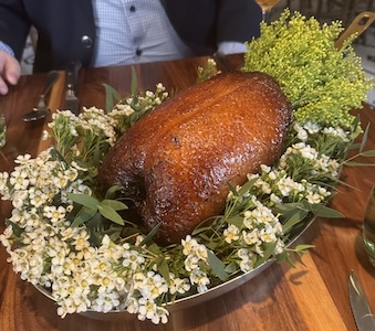 Roast duck collar in a plate of flowers from Francie restaurant