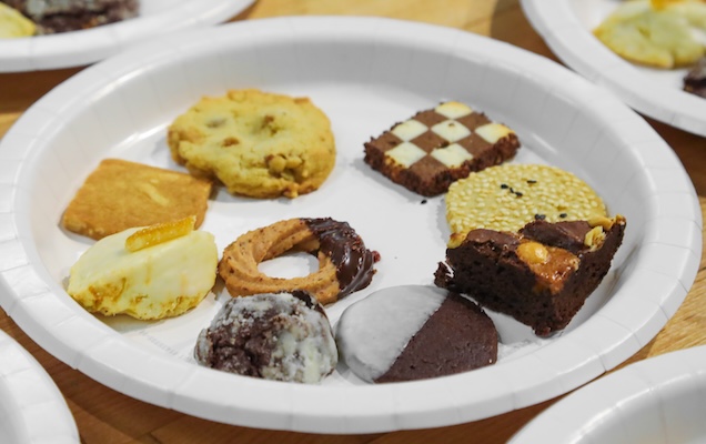 Nine different cookies on a paper plate