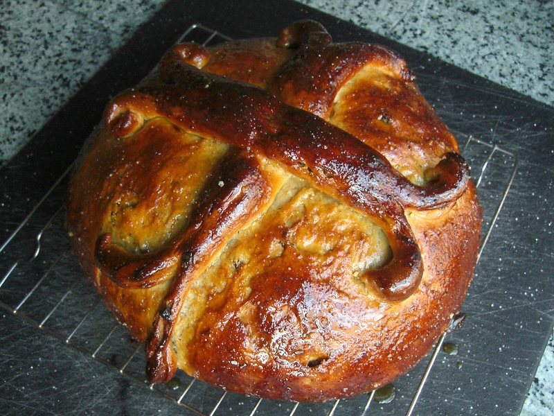 Christopsomo, a brown, round loaf of bread, sits on a cooling rack