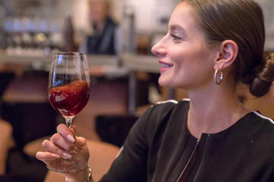 Women swirling red wine in a glass