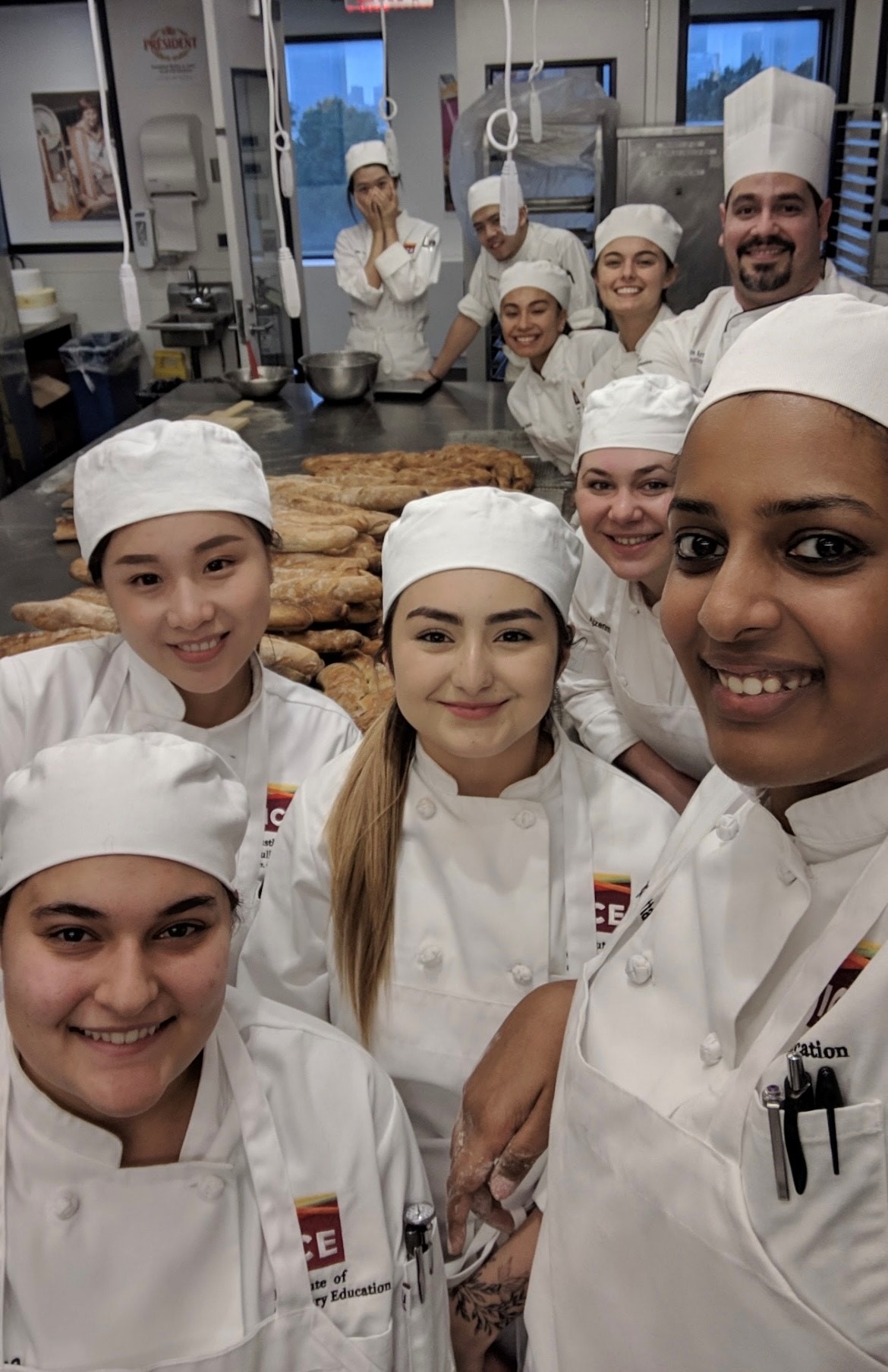 ICE alum Pragati Mita in chef whites with other ICE students.  