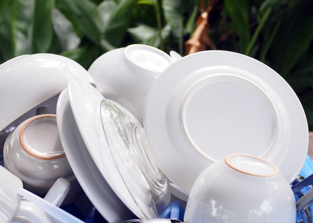 Clean white dishes on a blue dish tray