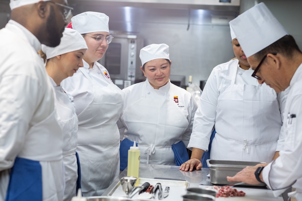 ICE students watching chef in the kitchen.