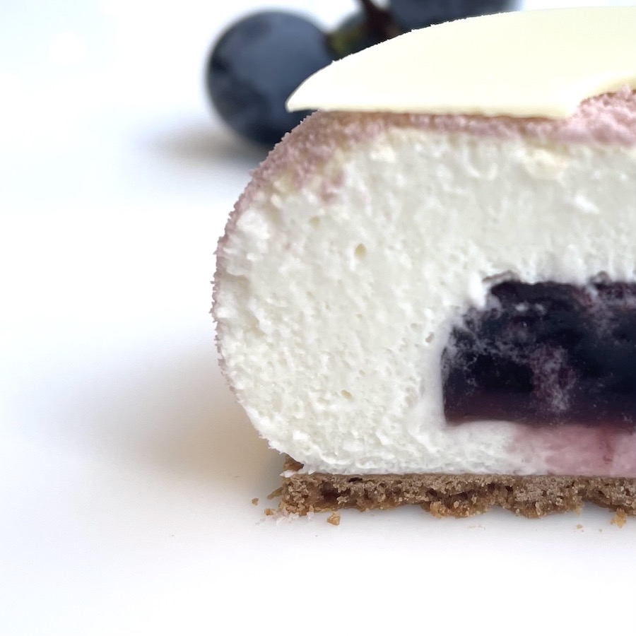 Concord grape jam filled cheesecake is cut in half