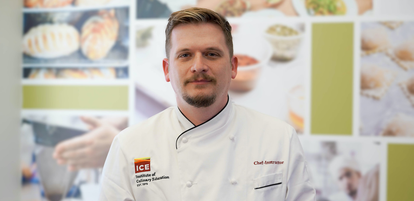 Chef-Instructor Shawn Matijevich stands in front of the ICE lobby background