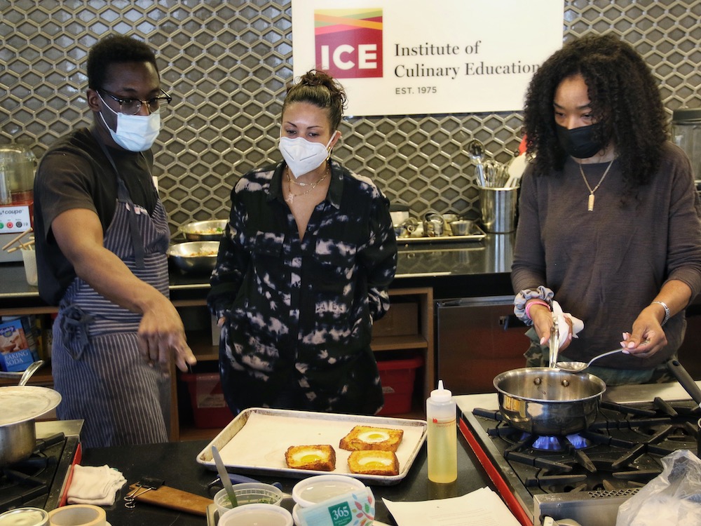 Chef Adrienne Cheatham works with her crew at a photoshoot for the coming cookbook.