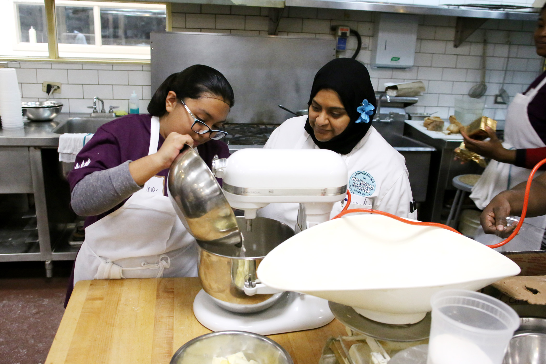 Naseem works with a student at Hot Bread Kitchen.
