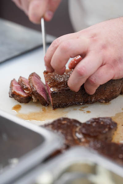 Katie Flannery slicing steak