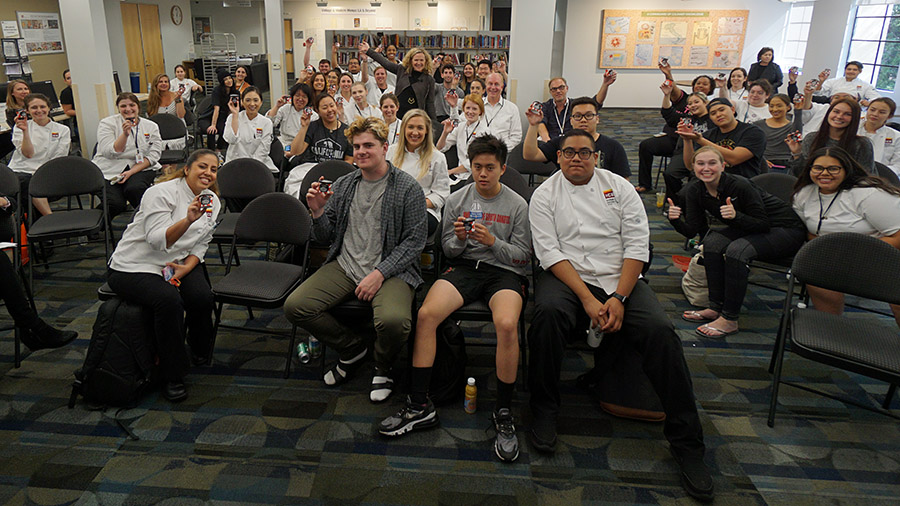 Kim Malek poses with ICE students after distributing ice cream samples during her guest lecture.