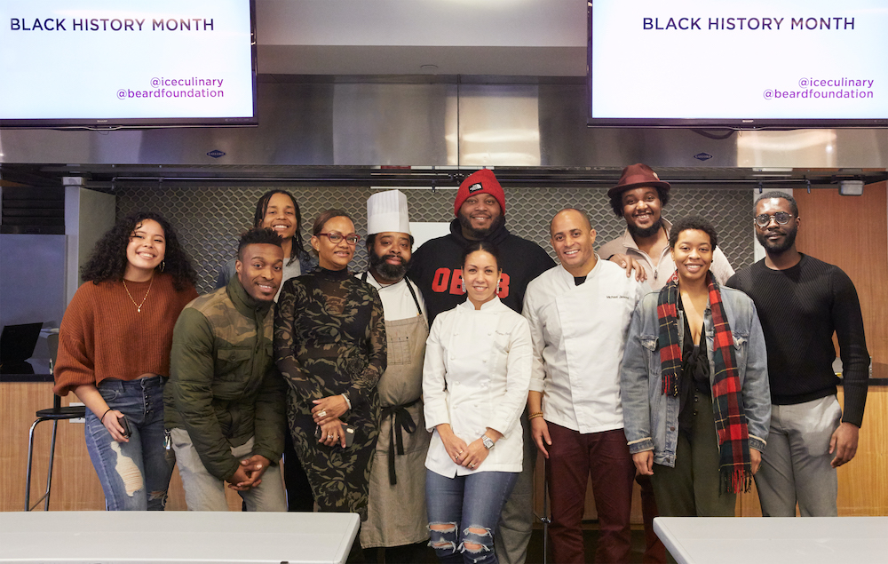 Students pose with guest chefs after a Black History Month panel at ICE