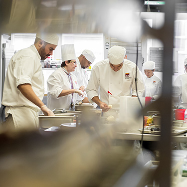 Culinary school students working in the kitchen classroom.jpg
