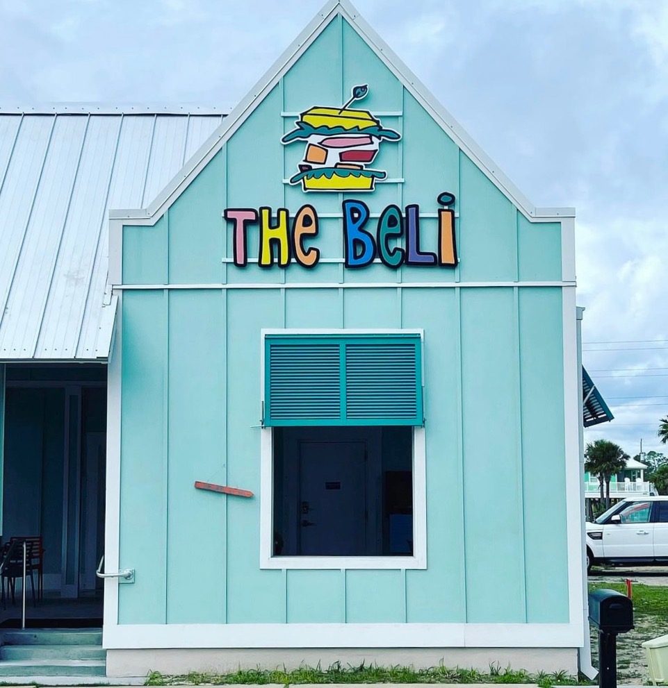 A teal building with a sign that reads "The Beli"