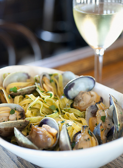 A bowl of clams and wine
