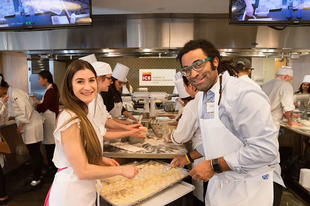 A pair of guests makes pasta at a special event at ICE.