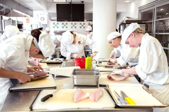 culinary students learning how to fabricate fish