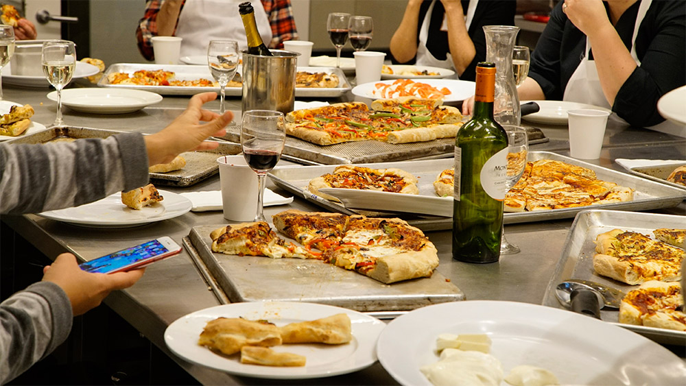 A recreational pizza class at ICE culminates in a group meal.