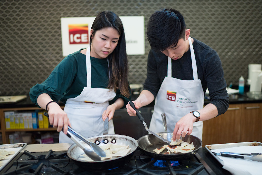 two students make dumplings in a rec class