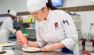 An ICE student practices plating beautiful desserts