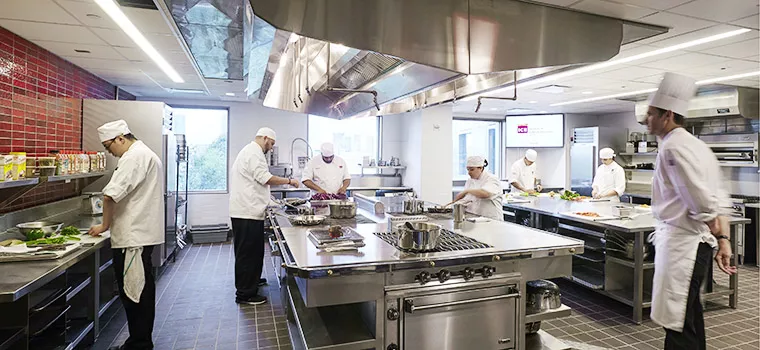 ICE students and a chef work in a kitchen