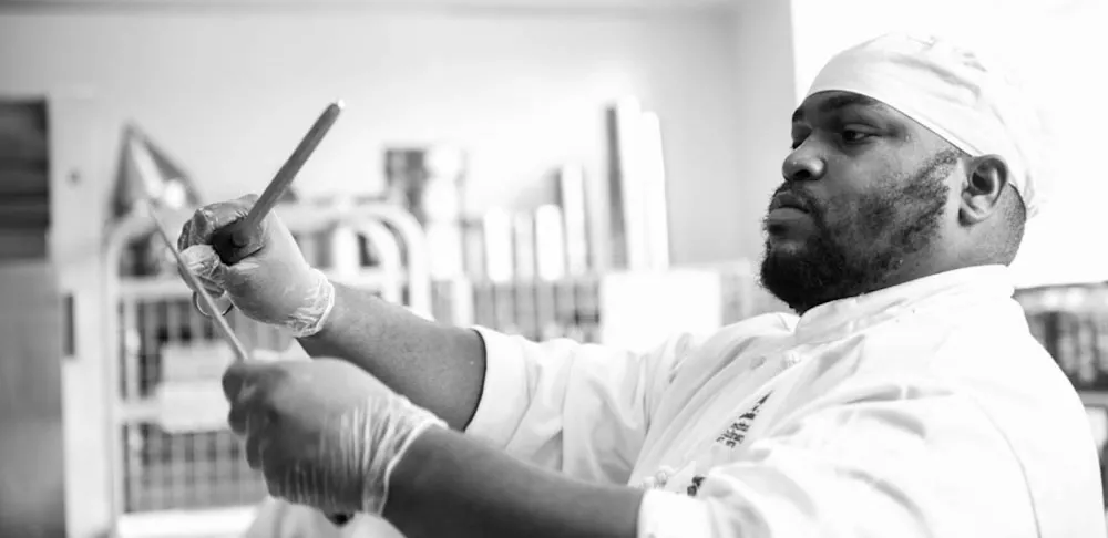 Chef sharpening his knives in a professional kitchen