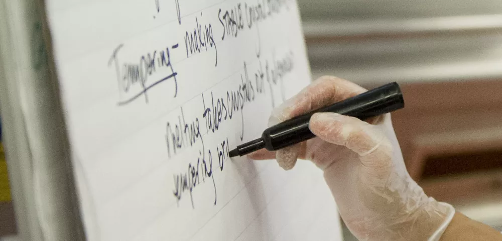 Person writing notes for culinary school