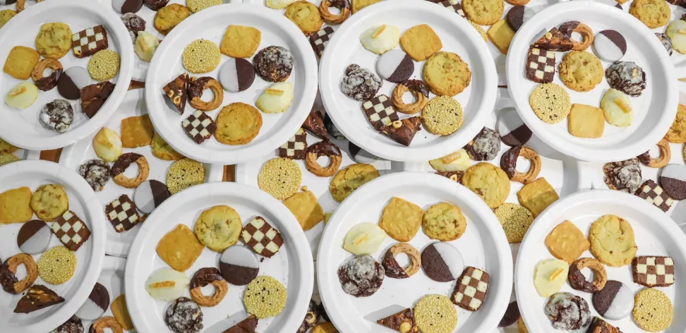 Plates with nine varieties of cookies piled on top of each other