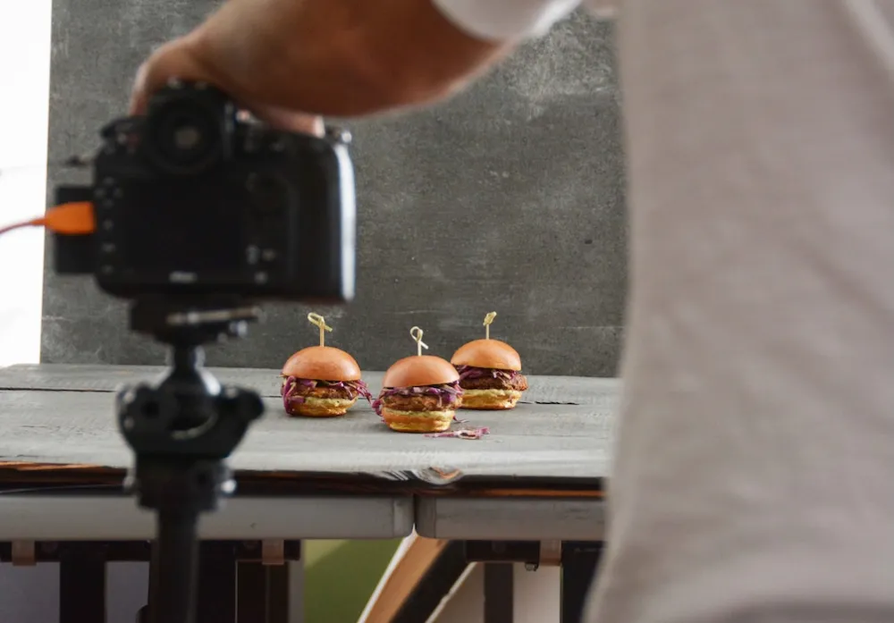 Hamburger sliders in front of a professional camera showing and example of food media.