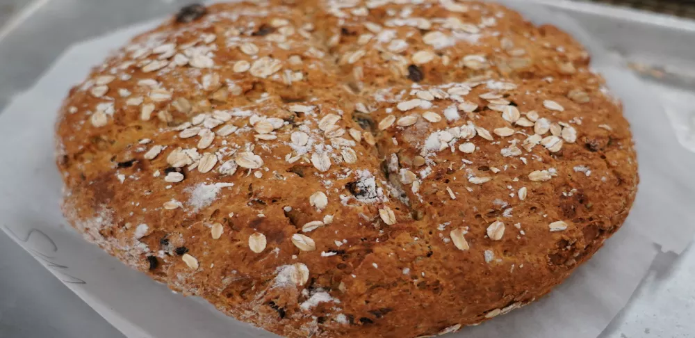 A loaf of Chef Sim Cass' Irish soda bread recipe sits on a piece of parchment paper