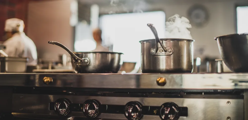 oven range and stove with steaming pots and pans