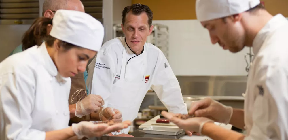 Michael working with students in the chocolate lab