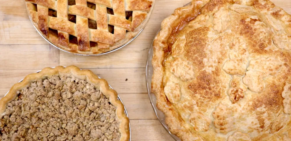 Three pies on a wooden table