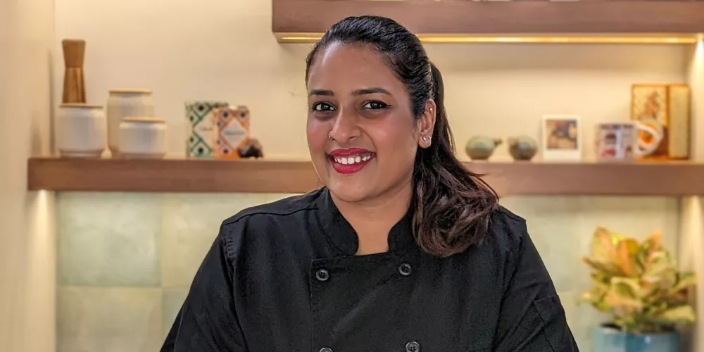 Pragati Mita smiles in black chef coat