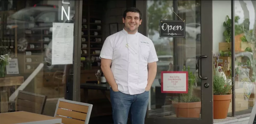 Chef Adriano Piazza smiles while standing in front of Pronto Cucina Italina