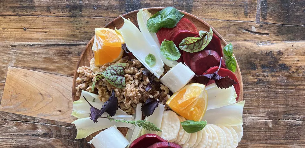 A fermented beet grazing board on a wooden plate