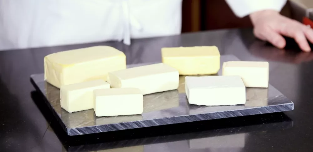 Sticks of butter sit on a tray