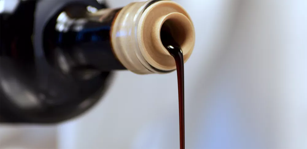 Balsamic vinegar pours from a bottle