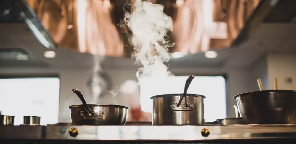 Pots on a stovetop range.