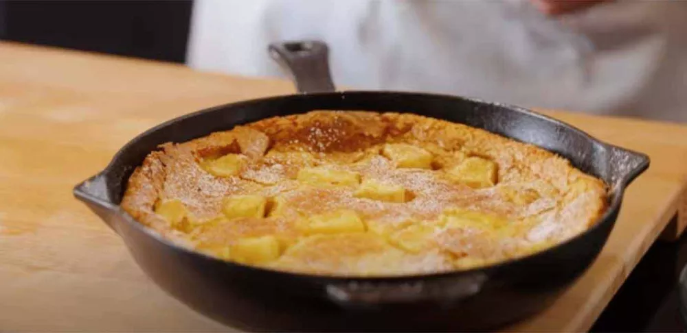 Pineapple clafoutis in a cast iron pan.