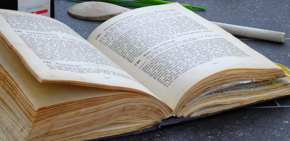 An open cookbook on the kitchen counter.