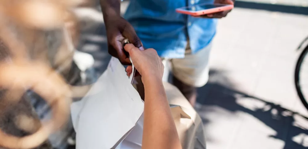 Delivery person handing off food