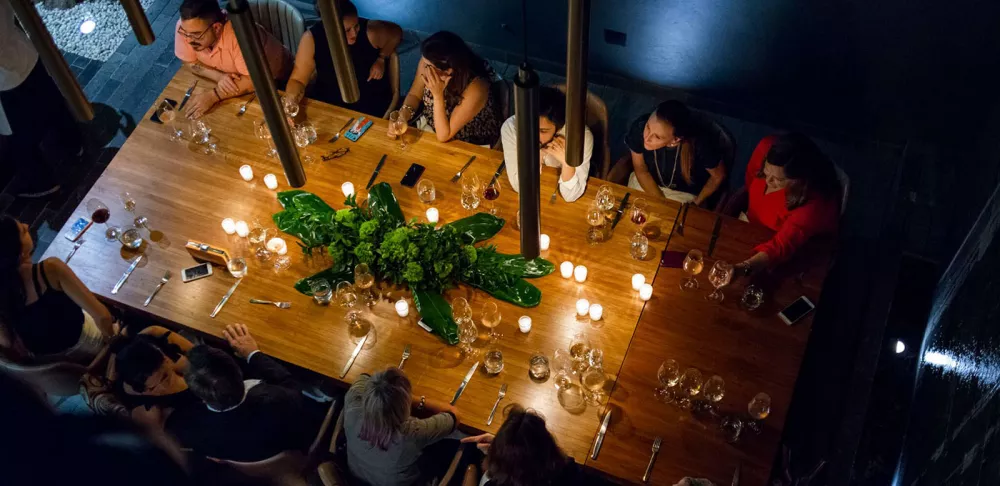 A group enjoy a Tepuy Collective pop-up dinner.