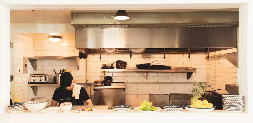 A man works the line at Emma's Torch in Brooklyn.